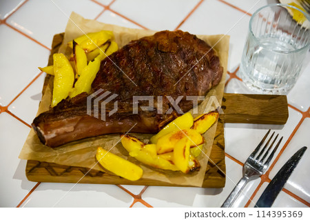 Beef entrecote with potatoes served at plate closeup Beef entrecote with potatoes served at plate closeup 114395369