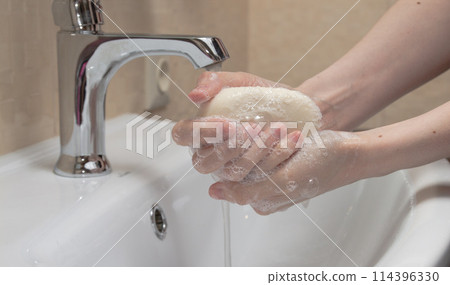 Hygiene. Cleaning Hands. Washing hands with soap. Woman's hand with foam. Protect yourself from coronavirus COVID-19 pandemia. 114396330