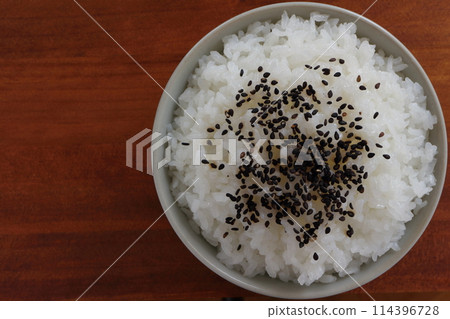 Black sesame rice served in a bowl on a table Black sesame rice served in a bowl on a table 114396728