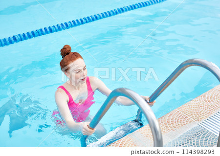 tired cheerful girl standing in the swimming pool tired cheerful girl standing in the swimming pool 114398293