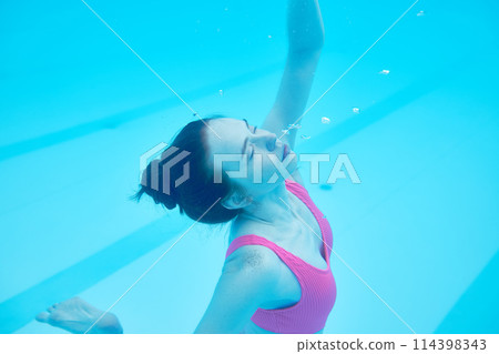 attractive girl with hair bun cannot swim in cold water 114398343
