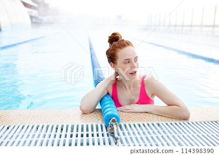 tired good-looking ginger swimmer looking aside 114398390