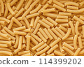 Chaotic Pile of Uncooked Rigatoni Pasta Background. Italian Pasta Tortiglioni 114399202