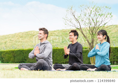 Men and women in sportswear doing yoga, meditation and mindfulness in the park (private lessons) Men and women in sportswear doing yoga, meditation and mindfulness in the park (private lessons) 114399840