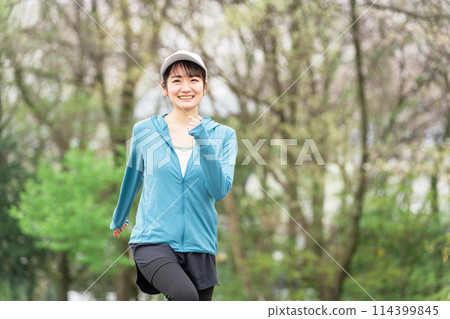 Asian woman in sportswear walking in the park for diet and calorie consumption Asian woman in sportswear walking in the park for diet and calorie consumption 114399845