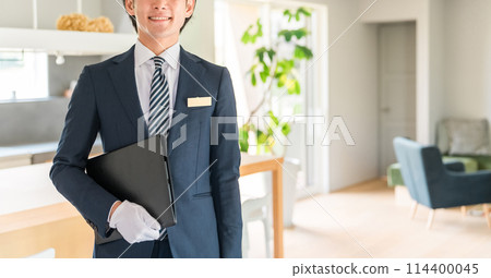 一位男性規劃師/銷售人員/房屋建築商顧問在房屋展廳/樣品屋周圍展示 一位男性規劃師/銷售人員/房屋建築商顧問在房屋展廳/樣品屋周圍展示 114400045
