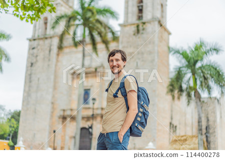Man tourist explores the vibrant streets of Valladolid, Mexico, immersing herself in the rich culture and colorful architecture of this charming colonial town Man tourist explores the vibrant streets of Valladolid, Mexico, immersing herself in the rich culture and colorful architecture of this charming colonial town 114400278