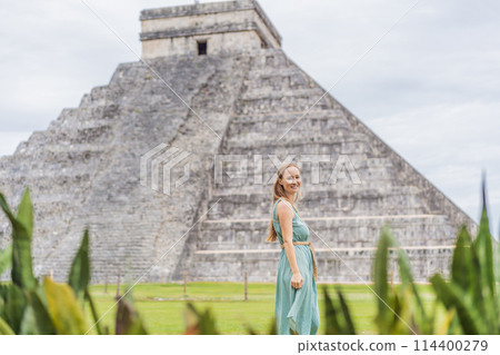 Beautiful tourist woman observing the old pyramid and temple of the castle of the Mayan architecture known as Chichen Itza these are the ruins of this ancient pre-columbian civilization and part of 114400279