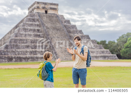 Father and son tourists observing the old pyramid and temple of the castle of the Mayan architecture known as Chichen Itza these are the ruins of this ancient pre-columbian civilization and part of 114400305
