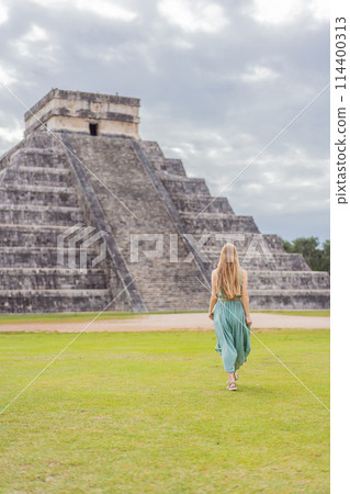 Beautiful tourist woman observing the old pyramid and temple of the castle of the Mayan architecture known as Chichen Itza these are the ruins of this ancient pre-columbian civilization and part of 114400313