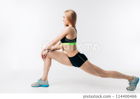 side view full length photo. slim ambitious girl is working out before running 114400466