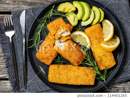 crispy baked battered pollock fillet on a plate 114401265
