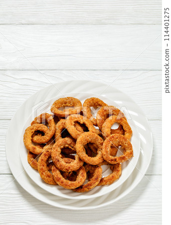 deep fried crispy onion rings on white plate 114401275