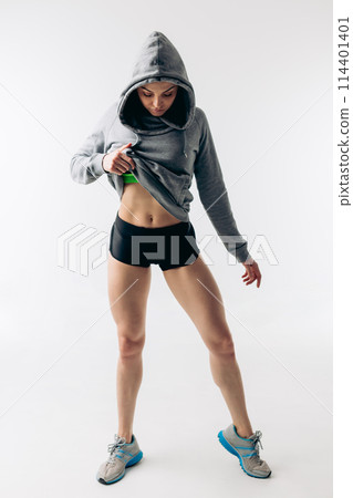 awesome attractive young girl is showing her perfect abs after workout awesome attractive young girl is showing her perfect abs after workout 114401401