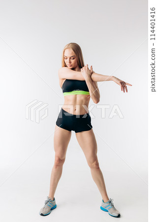 awesome beautiful sportswoman stretching arms and looking away awesome beautiful sportswoman stretching arms and looking away 114401416
