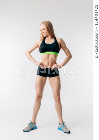 pleasant fitness woman with ideal waste is looking down pleasant fitness woman with ideal waste is looking down 114401422