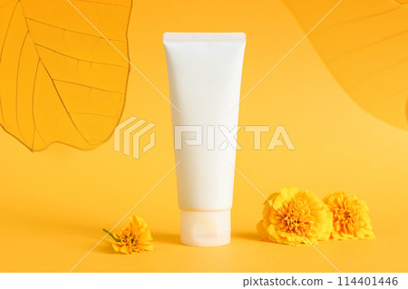 cosmetic moisturizer cream bottle tube, transparent leaves on yellow background. Shampoo, skincare, herbal facial cream, gel, sunblock sunscreen, sun skin protection. blank tube template mockup 114401446