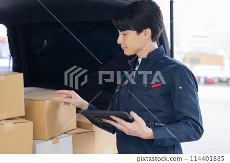 Logistics: A driver checking luggage on a tablet Logistics: A driver checking luggage on a tablet 114401885