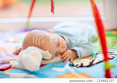 Little baby on white bed 114402157