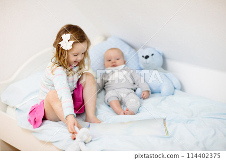 Kids in bed. Children in pajamas. Family bedroom. Kids in bed. Children in pajamas. Family bedroom. 114402375