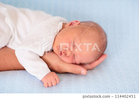 Newborn baby boy on a blue blanket Newborn baby boy on a blue blanket 114402451