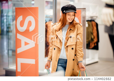 Happy caucasian woman with shopping bags, happy to shop Happy caucasian woman with shopping bags, happy to shop 114402882