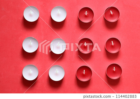 Decorative candles arranged in a row. On a pink background. Decorative candles arranged in a row. On a pink background. 114402883
