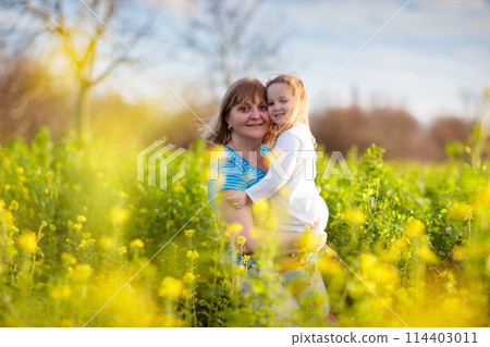 Mother and child in flower field Mother and child in flower field 114403011