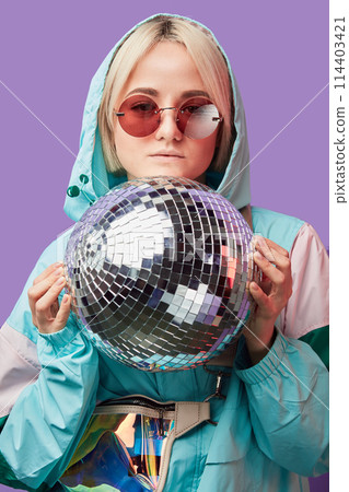 Beautiful lovely young Asian woman posing with silver discoball 114403421