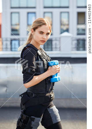 sporty girl with blue dumbbell sporty girl with blue dumbbell 114403463