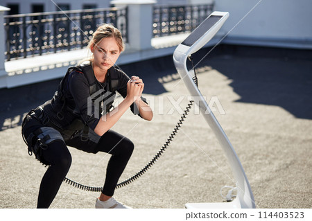 health all over the body. attractive female using fitness machine while training health all over the body. attractive female using fitness machine while training 114403523