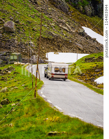 Car with trailer in mountains, Norway 114403944