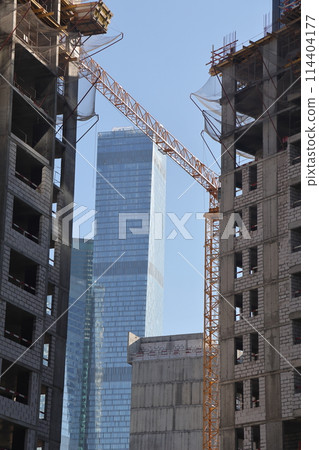 Construction site with cranes against the sky. Construction machinery, construction of skyscrapers. 114404177