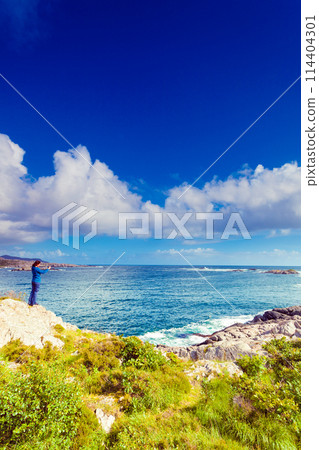 Woman tourist taking photo with camera in Norway 114404301