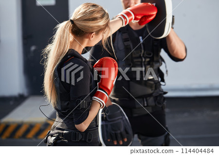 sporty girl is working out with boxing gloves sporty girl is working out with boxing gloves 114404484