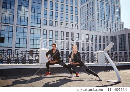 two gorgeous athletes are working out on the roof two gorgeous athletes are working out on the roof 114404514