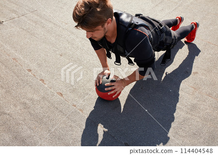 awesome sportsman is doing exercises with a ball 114404548