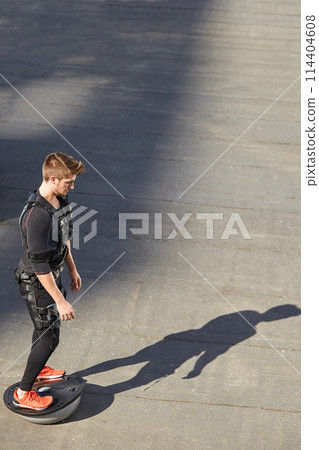 fir guy is standing on the bosu ball. training device conceptaerobic activity fir guy is standing on the bosu ball. training device conceptaerobic activity 114404608
