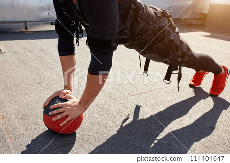 close up cropped photo of a fit sporty man training with a ball 114404647