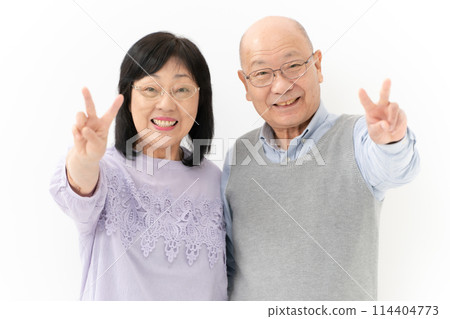 Senior couple peace sign 114404773