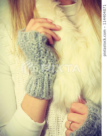 Sensitive female hands with gray gloves. 114404871