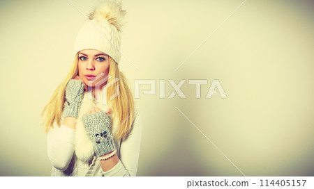 Woman wearing warm winter clothing Woman wearing warm winter clothing 114405157