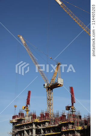 Construction site with cranes against the sky. Construction machinery, construction of skyscrapers. Construction site with cranes against the sky. Construction machinery, construction of skyscrapers. 114405203