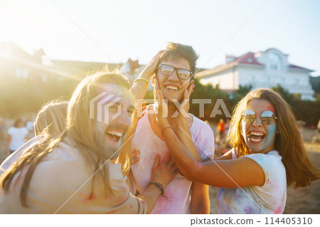 Teenagers Friends have fun at the holi festival. Beach Party. Celebrating traditional indian spring holiday. 114405310
