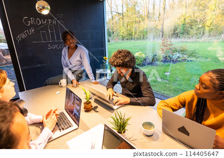 Diverse Team Celebrating Success in Modern Office 114405647