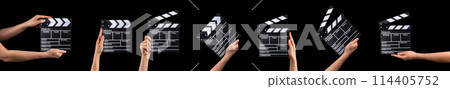 Human hand holding film clapper board isolated on black background. 114405752