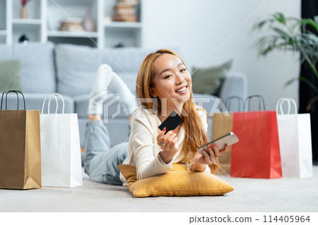 Happy Young Woman Enjoying Online Shopping At Home Happy Young Woman Enjoying Online Shopping At Home 114405964