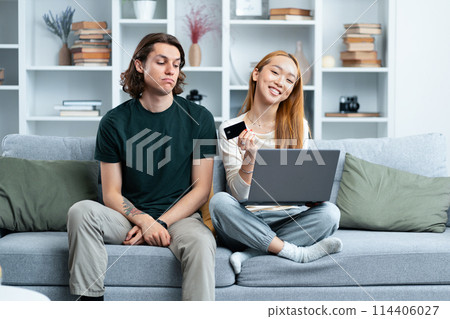 Young Couple Shopping Online Together on Laptop at Home Young Couple Shopping Online Together on Laptop at Home 114406027