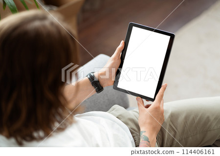 Young Woman Using Digital Tablet With Blank Screen At Home Young Woman Using Digital Tablet With Blank Screen At Home 114406161