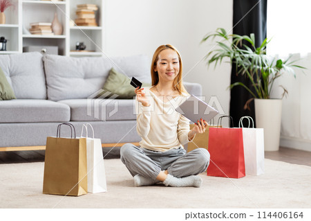 Young Woman Shopping Online With Credit Card And Tablet 114406164